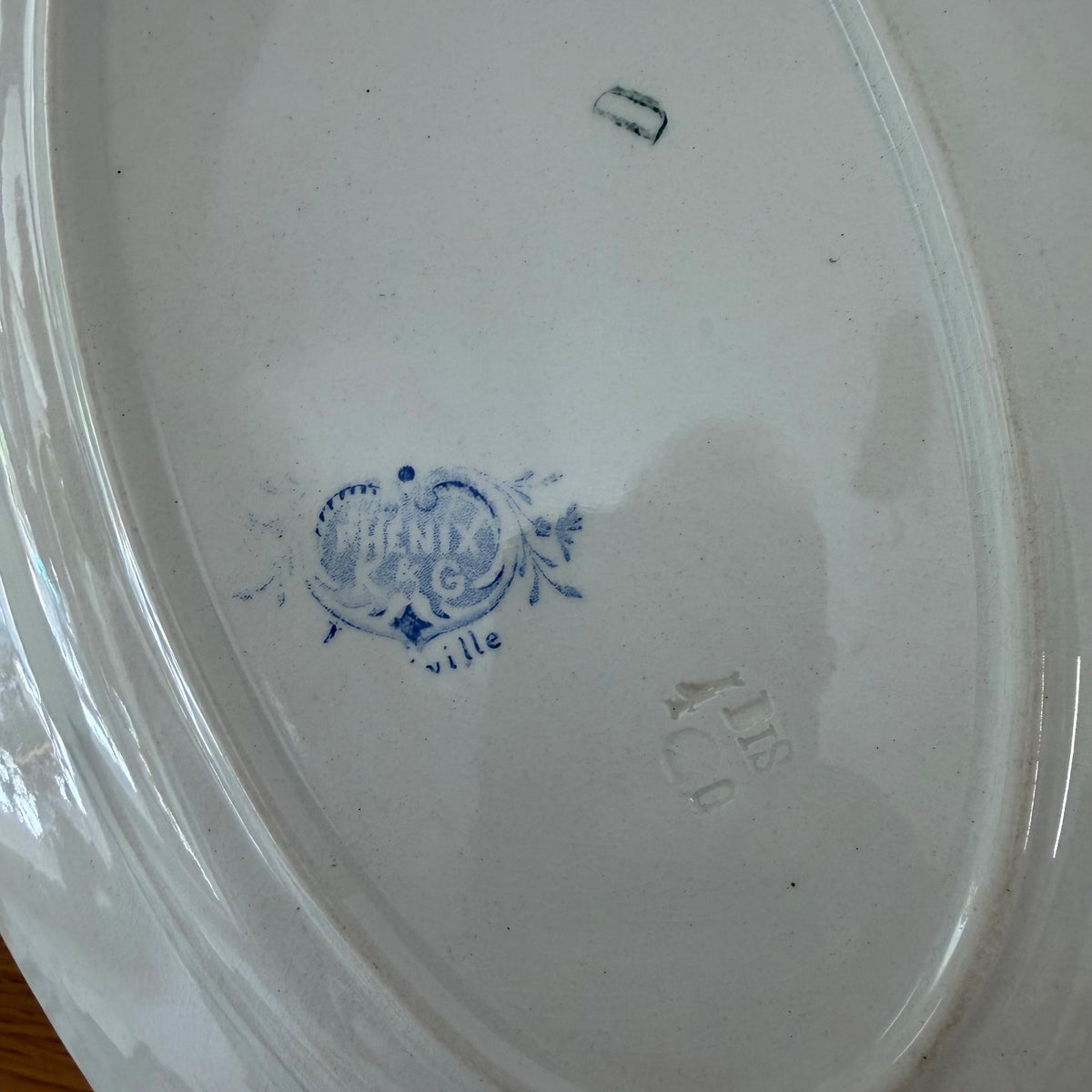 Base of antique Luneville platter showing Phenix K&G Luneville factory backstamp and markings