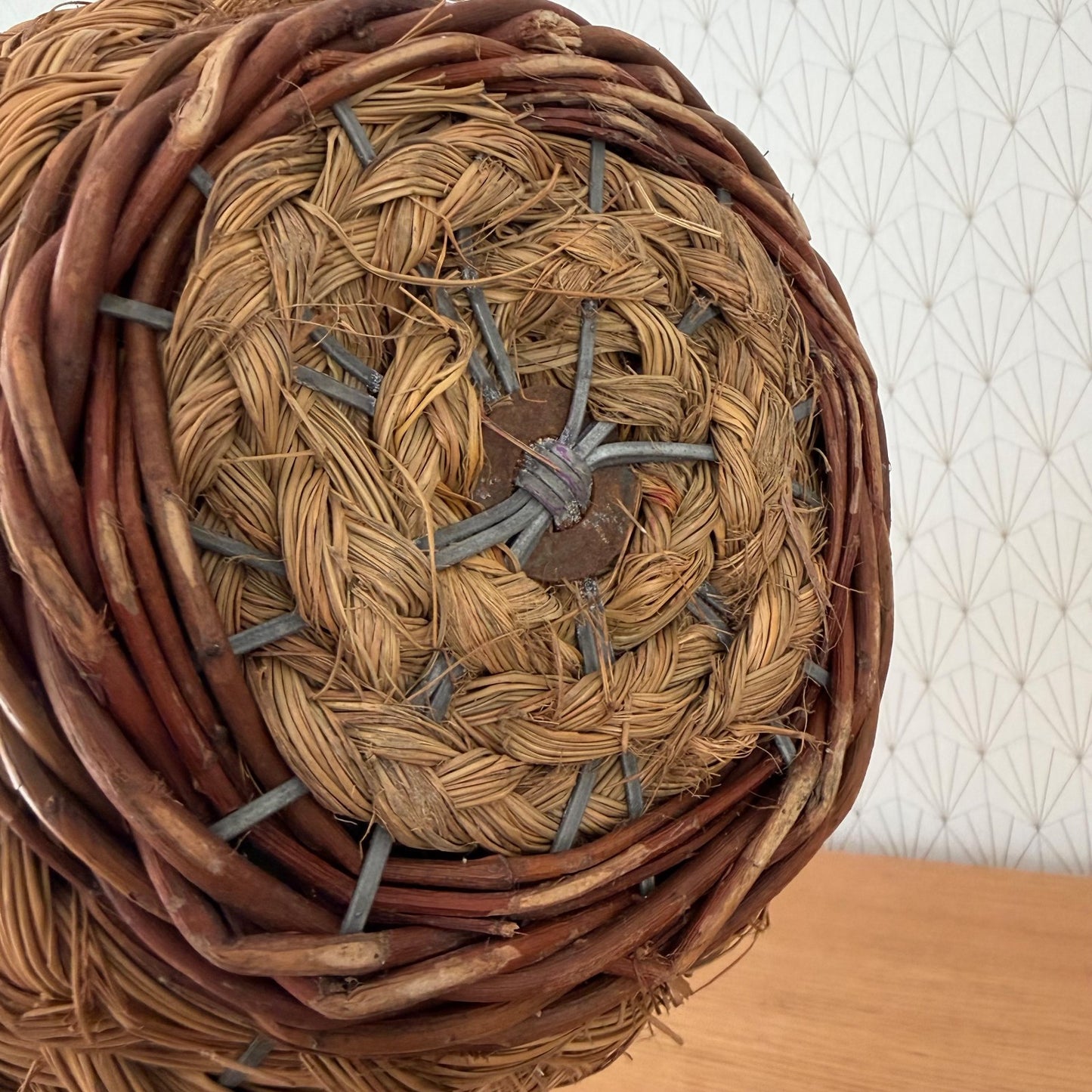 Inside view of French rattan demijohn basket showing woven construction and metal fasteners