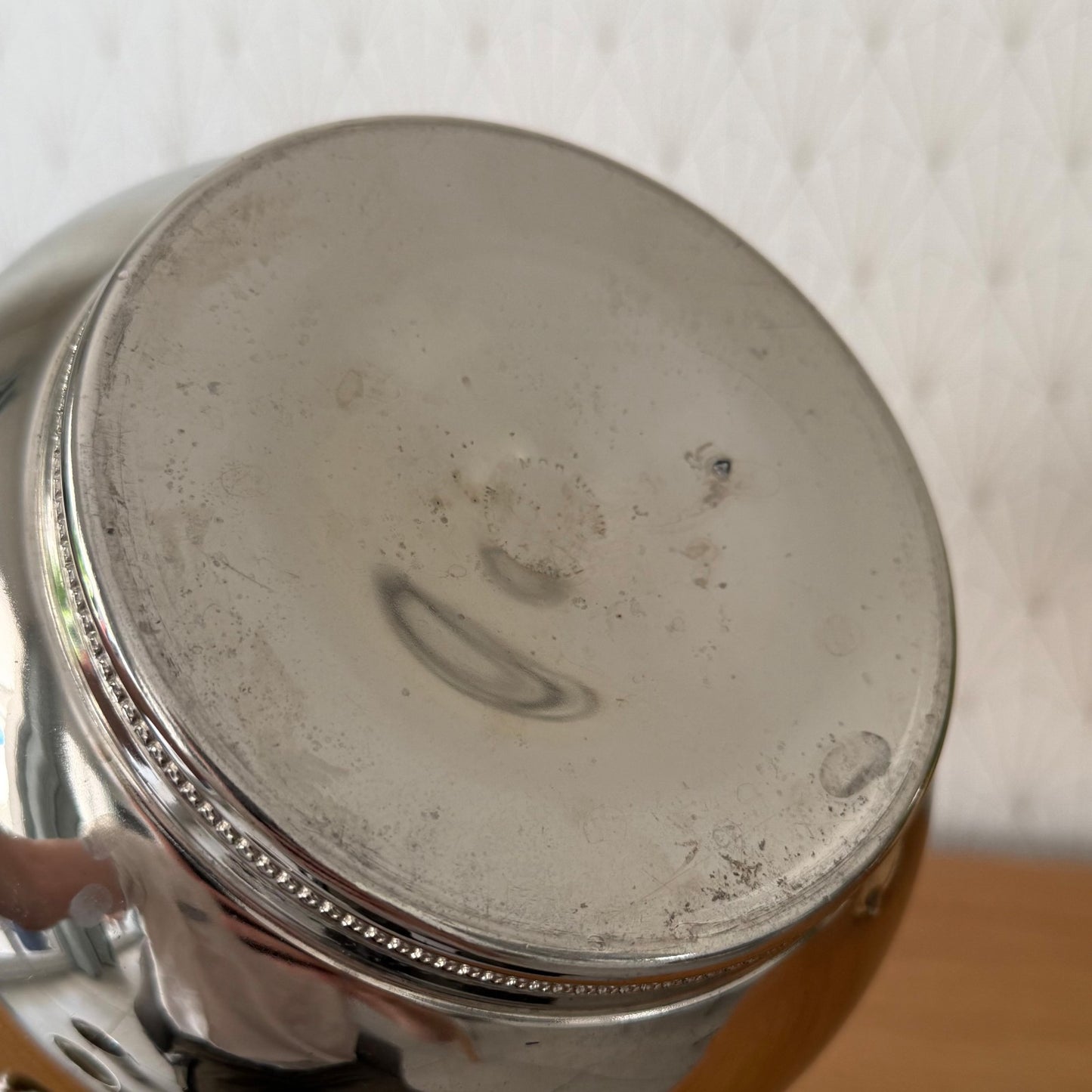 Bottom view of ice bucket displaying maker's mark and patina