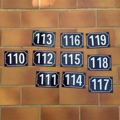 Authentic vintage French municipal enamel house number signs 110 to 119 featuring white numerals on deep blue enamel background mounted on heavy gauge steel with aged patina