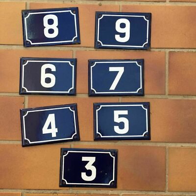 Seven French municipal porcelain enamel number plaques 3 through 9 with white numerals on cobalt navy blue background with white border trim showing natural patina from street installation