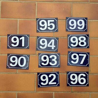 Vintage French municipal house number plaque with bold white numeral on deep blue enamel background, heavy steel construction, 10x15cm, showing authentic wear from decades of outdoor use in France