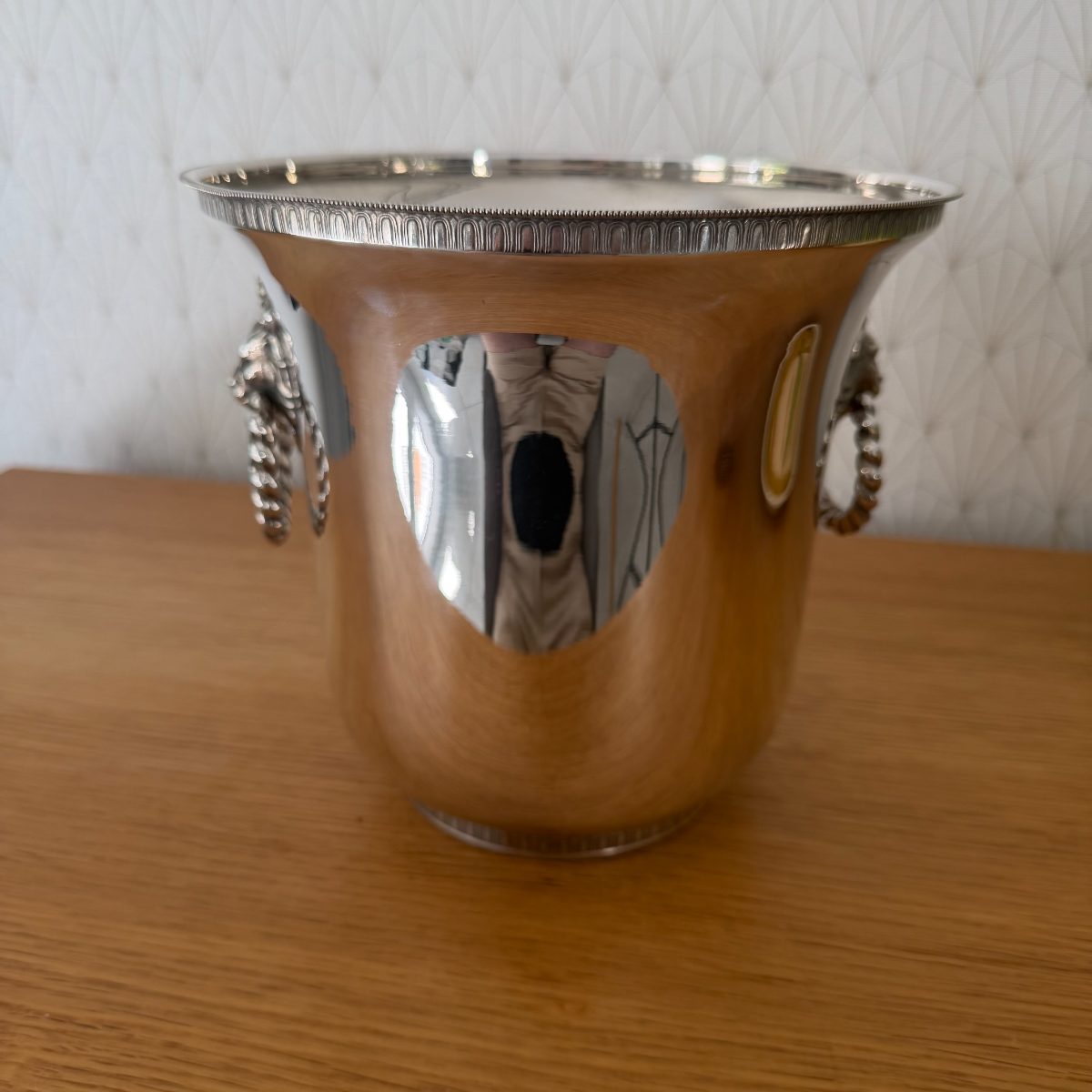Angled top view of vintage French silver plated champagne cooler showing both lion head ring handles and engraved arch rim detail.