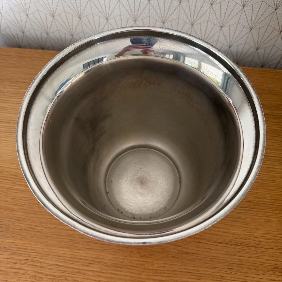 Interior view looking down into French silver plated champagne bucket showing clean unlined metal interior with raised center boss.