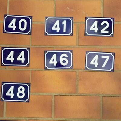 Set of seven vintage French municipal enamel house number plates in blue and white, numbers 40 41 42 44 46 47 48, glazed steel with authentic wear, France mid-20th century.
