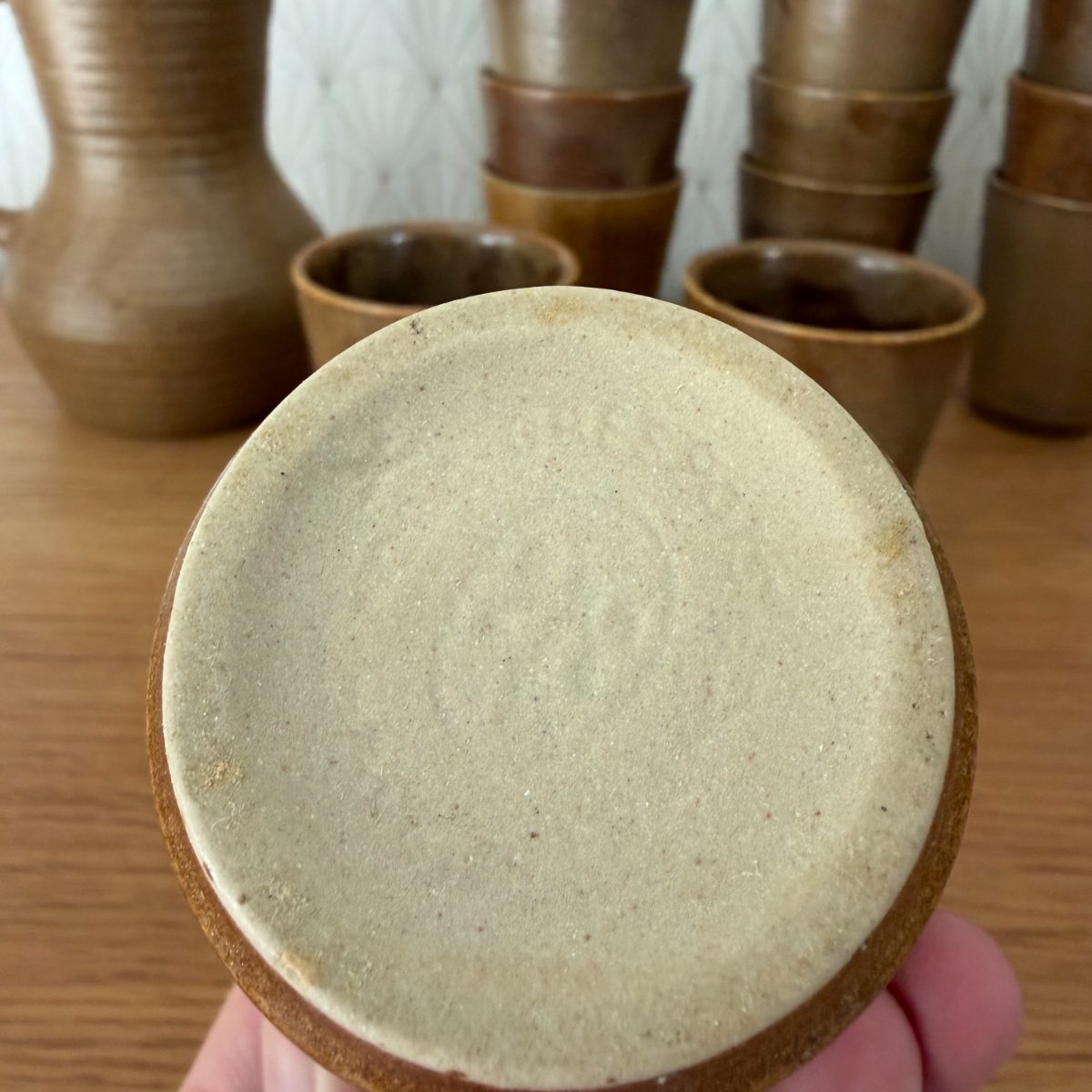 Unglazed pale stoneware base of a French vintage cup showing flat foot and natural clay texture
