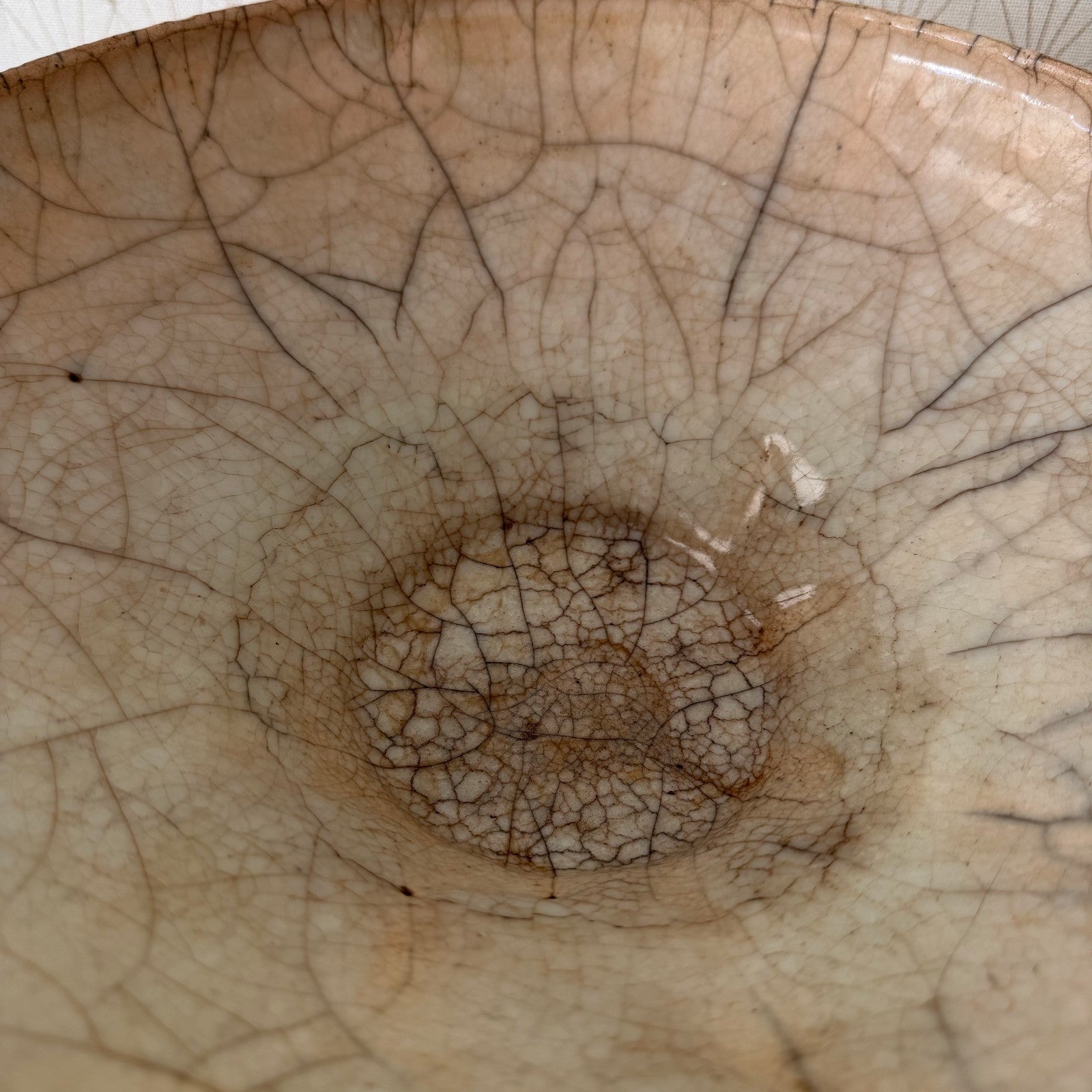 Side profile of antique French crackle pottery bowl revealing footed pedestal base and curved rim detail