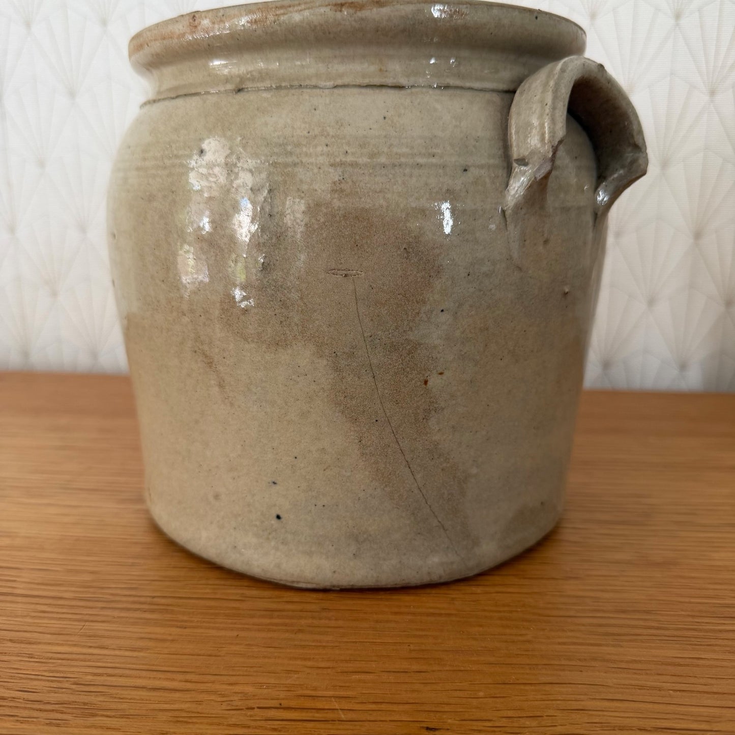 Side profile of vintage French confit pot showing applied handles and rim detail
