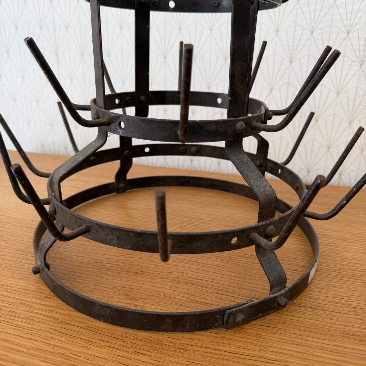 Side profile of antique French bistro bottle drying rack revealing stepped tiered structure