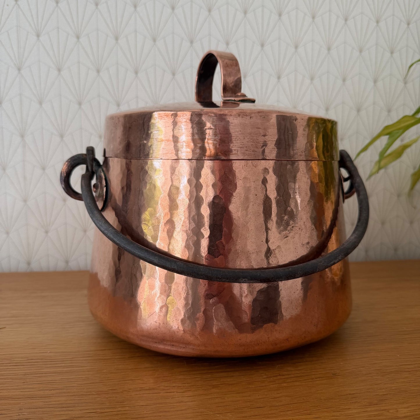 Front view of vintage French copper cauldron with brass feet and working latch detail