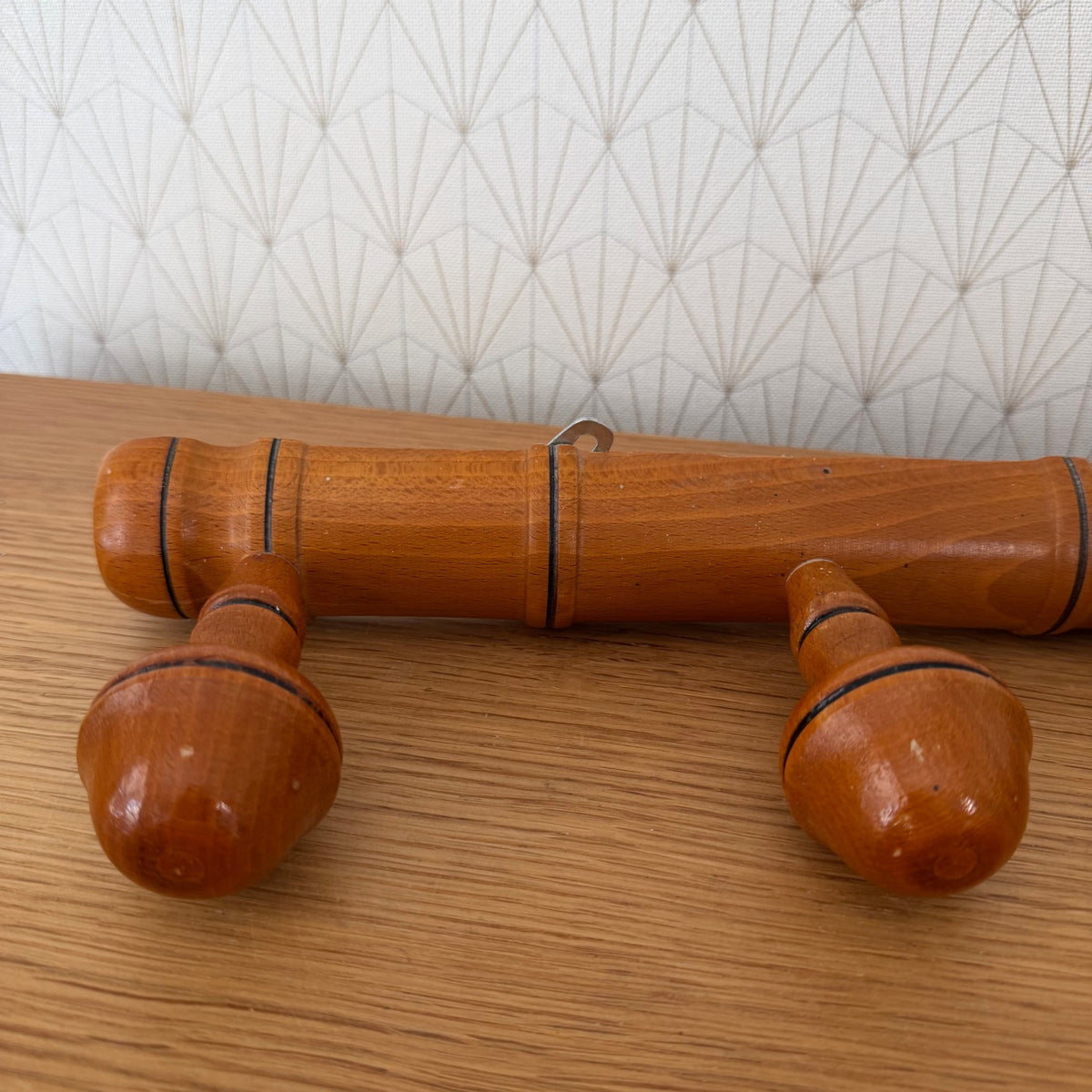 Close-up detail of turned wooden pegs on French bamboo coat rack