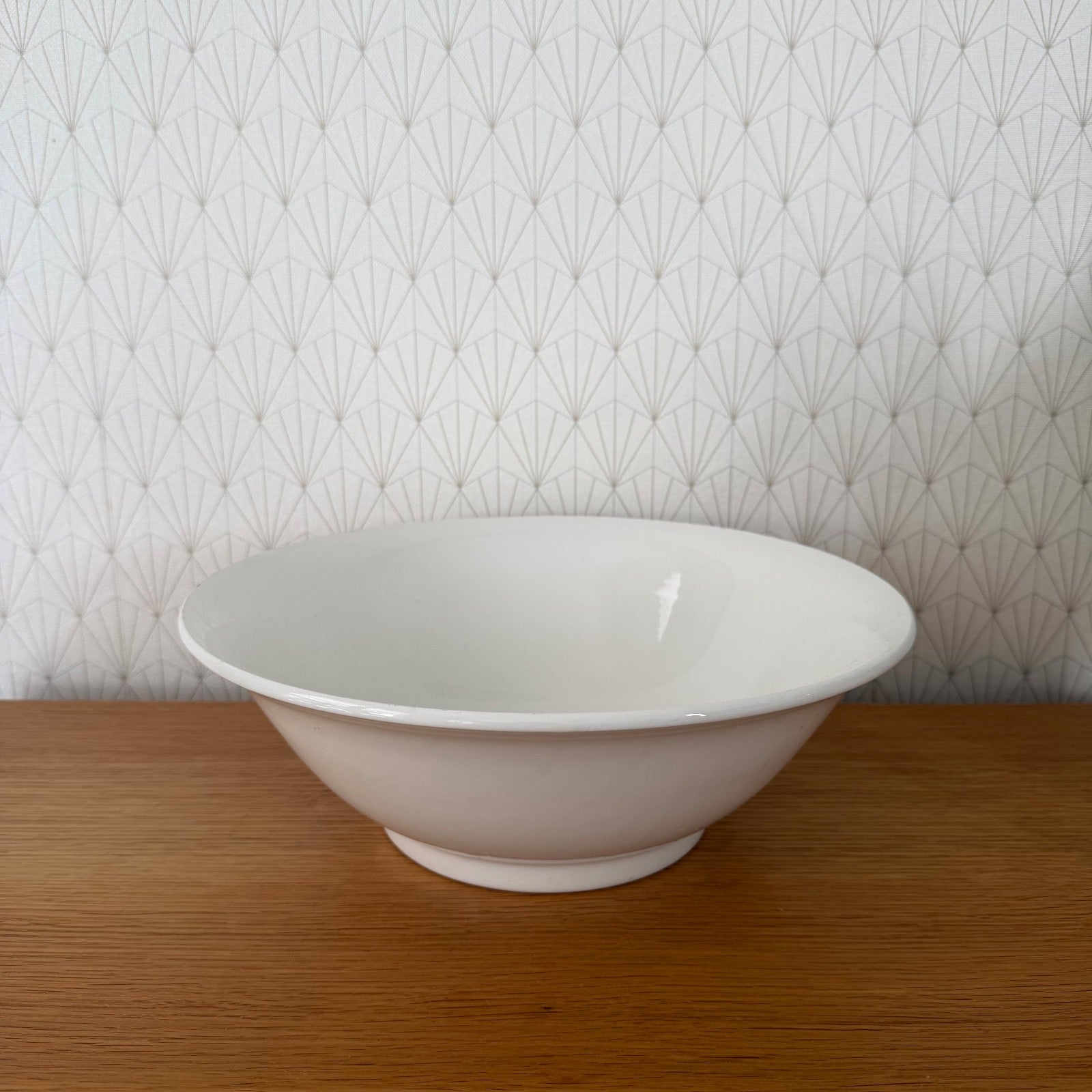 White glazed ceramic pedestal fruit bowl, empty, side view showing classic French form
