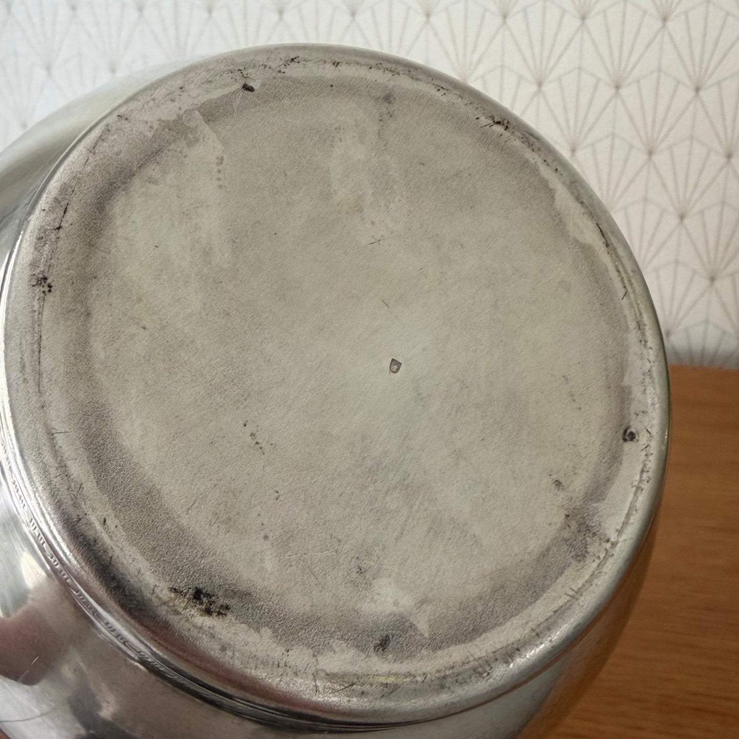 Overhead view of French silverplate champagne ice bucket with decorative engraved rim detail