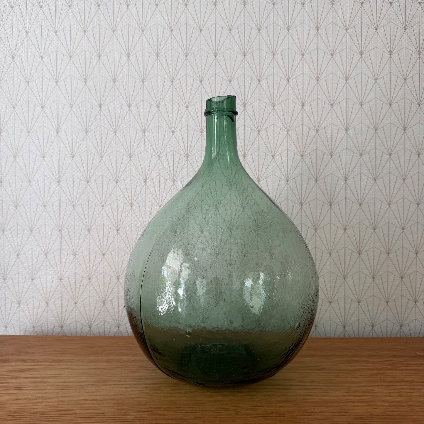 Antique French Dame Jeanne glass demijohn bottle with green tinted glass and cork stopper, front view