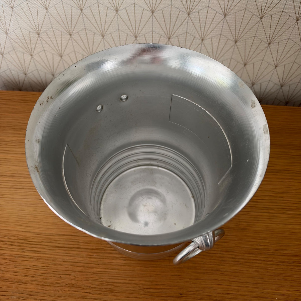Interior view of polished aluminum champagne ice bucket showing depth and spun construction