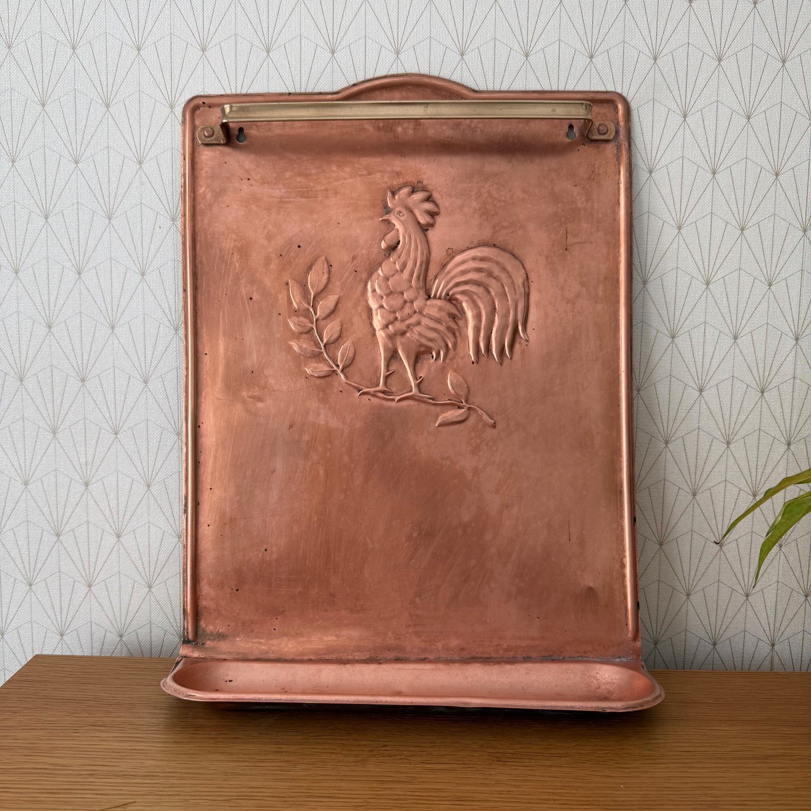 Vintage French copper utensils hanger with rooster and plant relief, front view mounted on wall