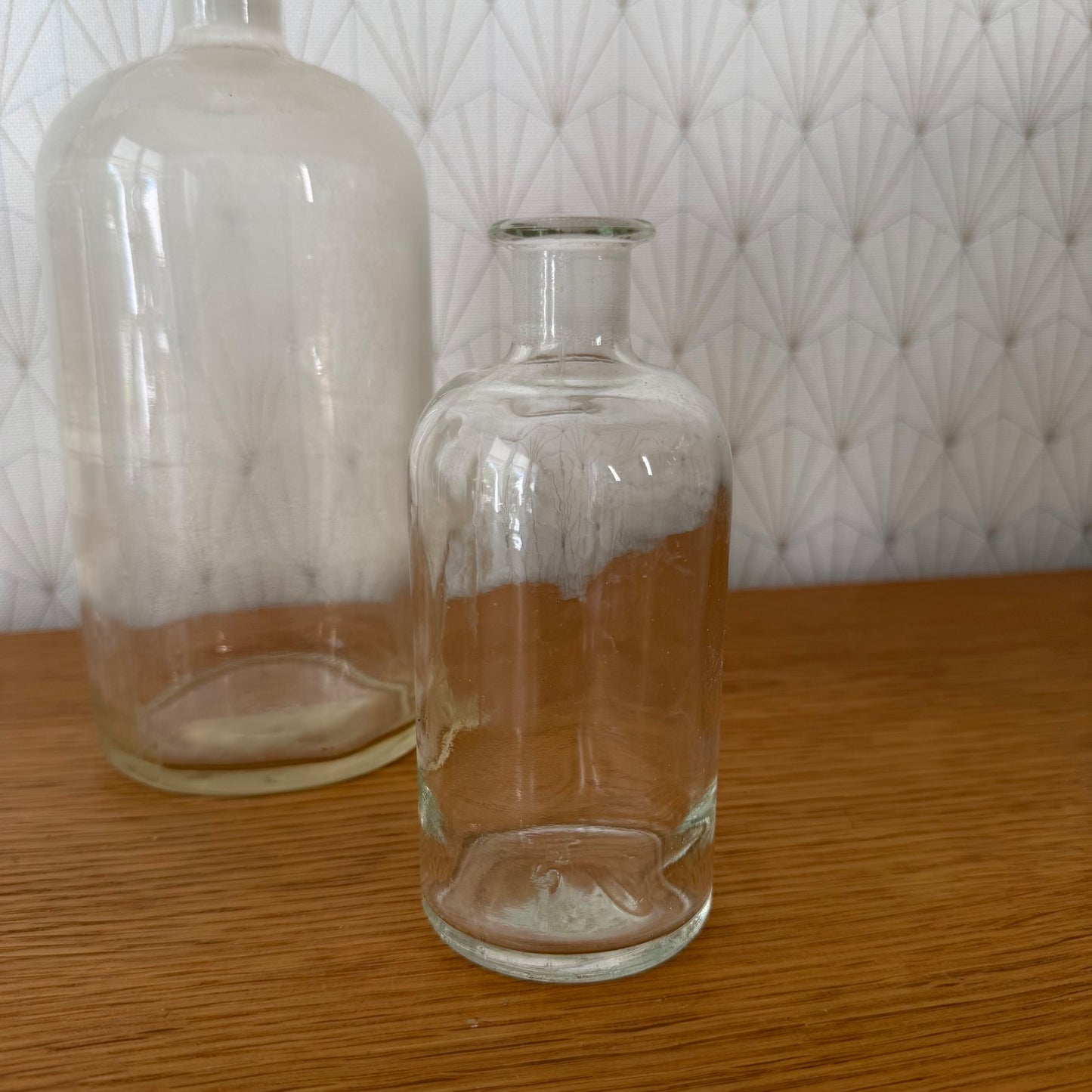 Detail view of French apothecary glass bottle with round stopper and vintage laboratory glass patina