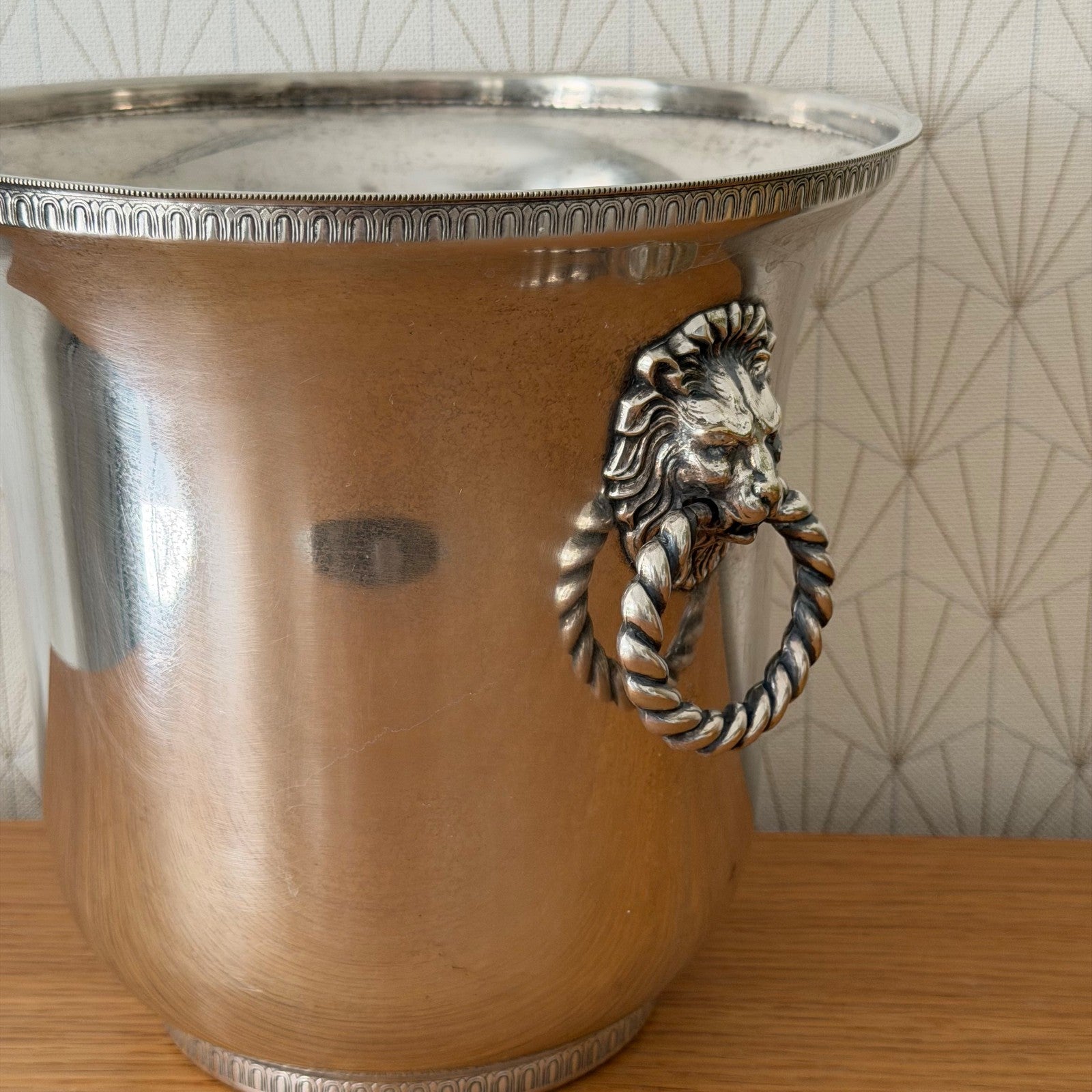 Profile view of tapered tulip-form French silverplate champagne ice bucket with engraved bands