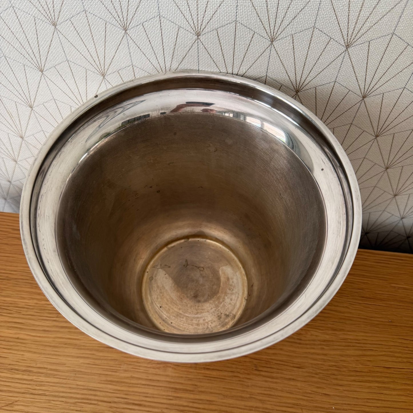 Side profile of vintage French silverplate ice bucket with lion handles and patina