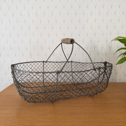 Vintage French wire harvesting basket with wooden handle, side view