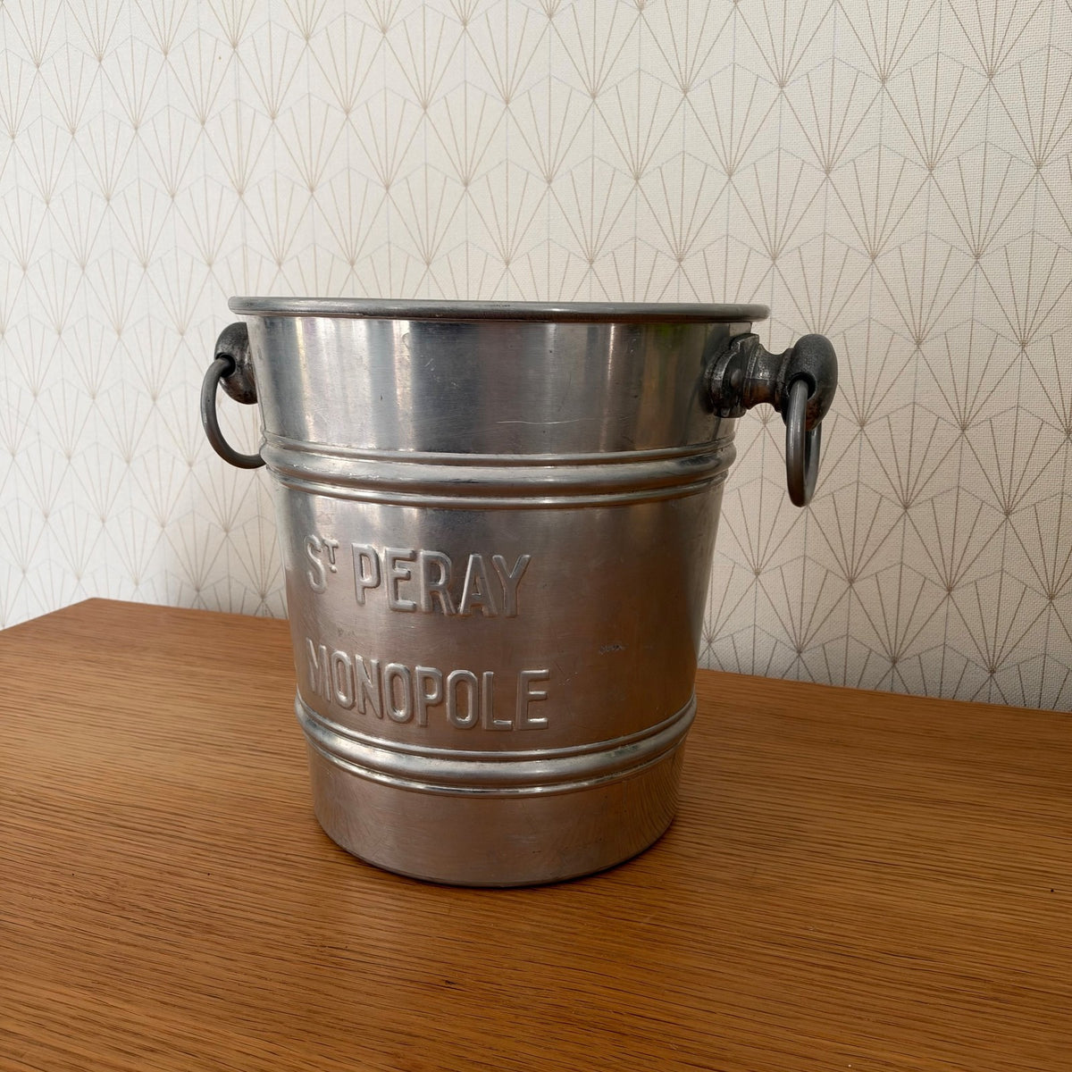 Side profile of French St Peray Monopole champagne bucket showing cylindrical aluminum form and handles