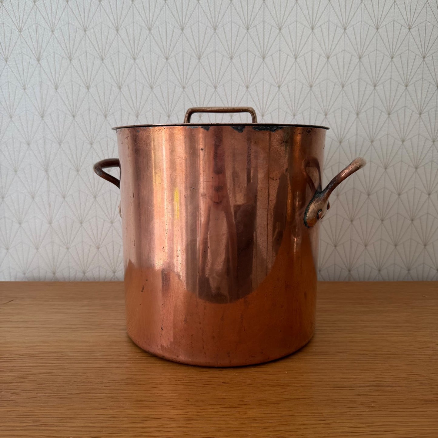 Antique French copper stock pot with brass top handle and original lid, front view