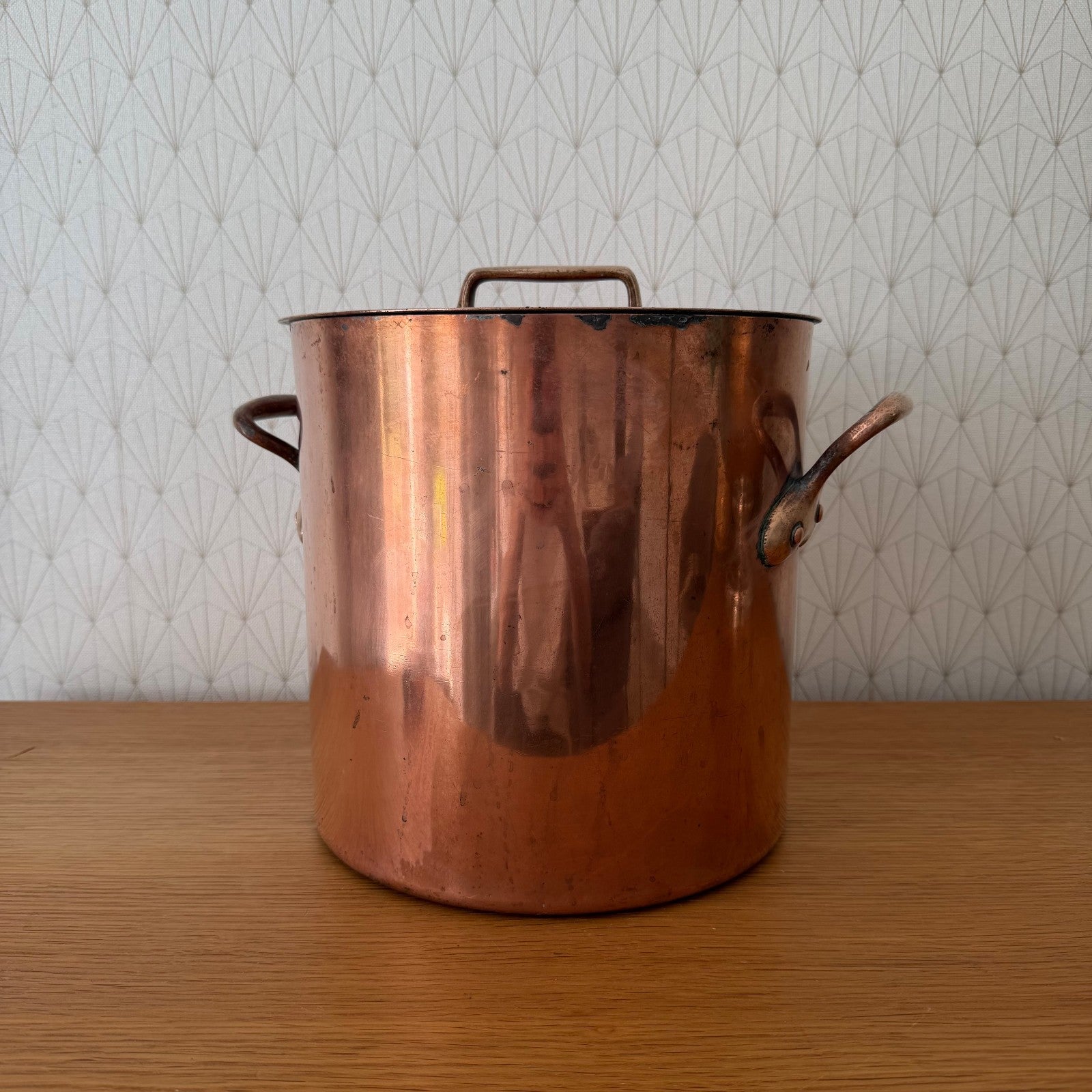 Antique French copper stock pot with brass top handle and original lid, front view