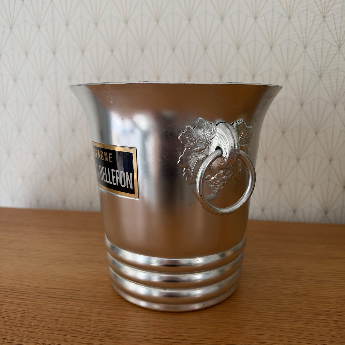 Close-up of Besserat de Bellefon branded label on aluminum champagne bucket