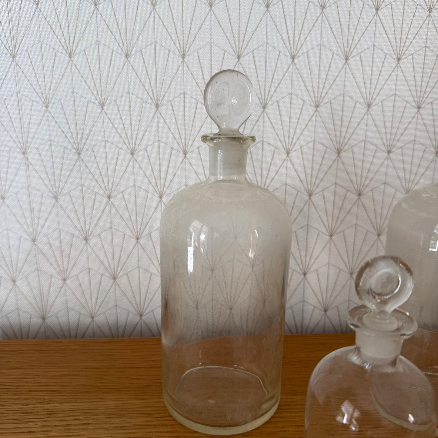 Close-up of single French apothecary bottle with ground-fit glass stopper showing hand-blown glass detail