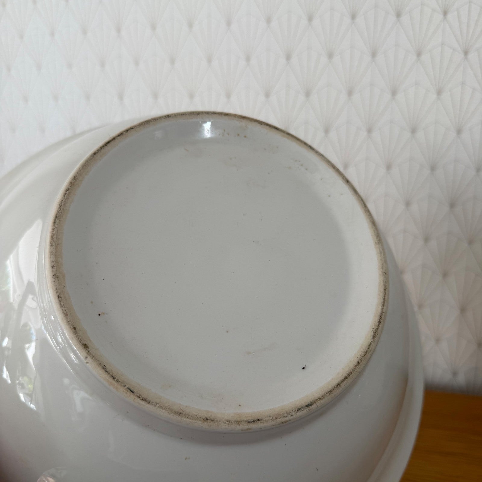 Close-up of bowl's interior showing white glaze and maker's mark ring on base