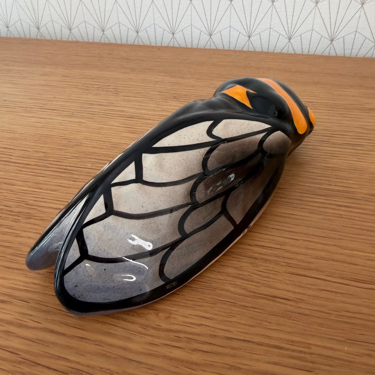 Vintage French cicada wall pocket showing cream interior wings with black vein detailing