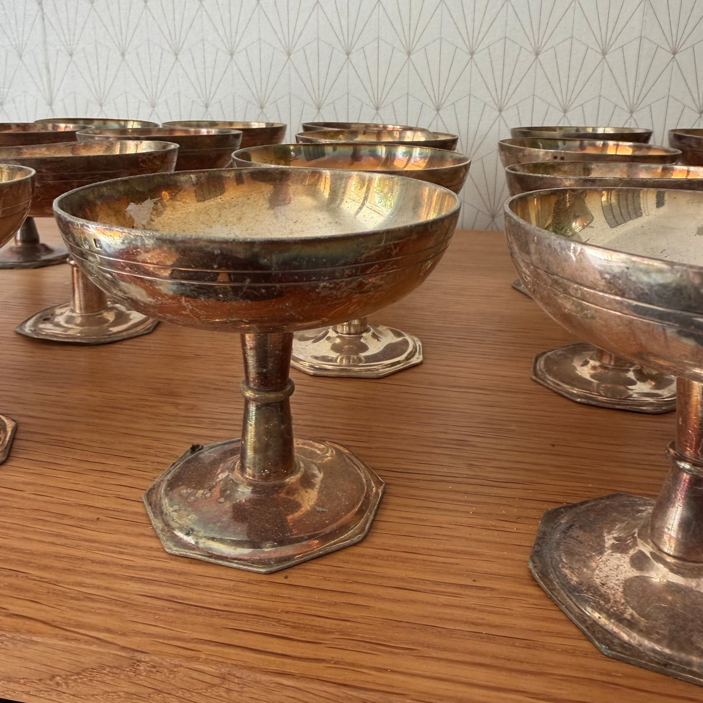 Group of vintage silverplate champagne coupes pedestals showing octagonal base design and silver plating wear