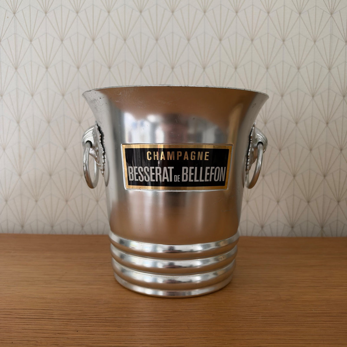 Side profile of vintage French champagne bucket with decorative grape vine handles