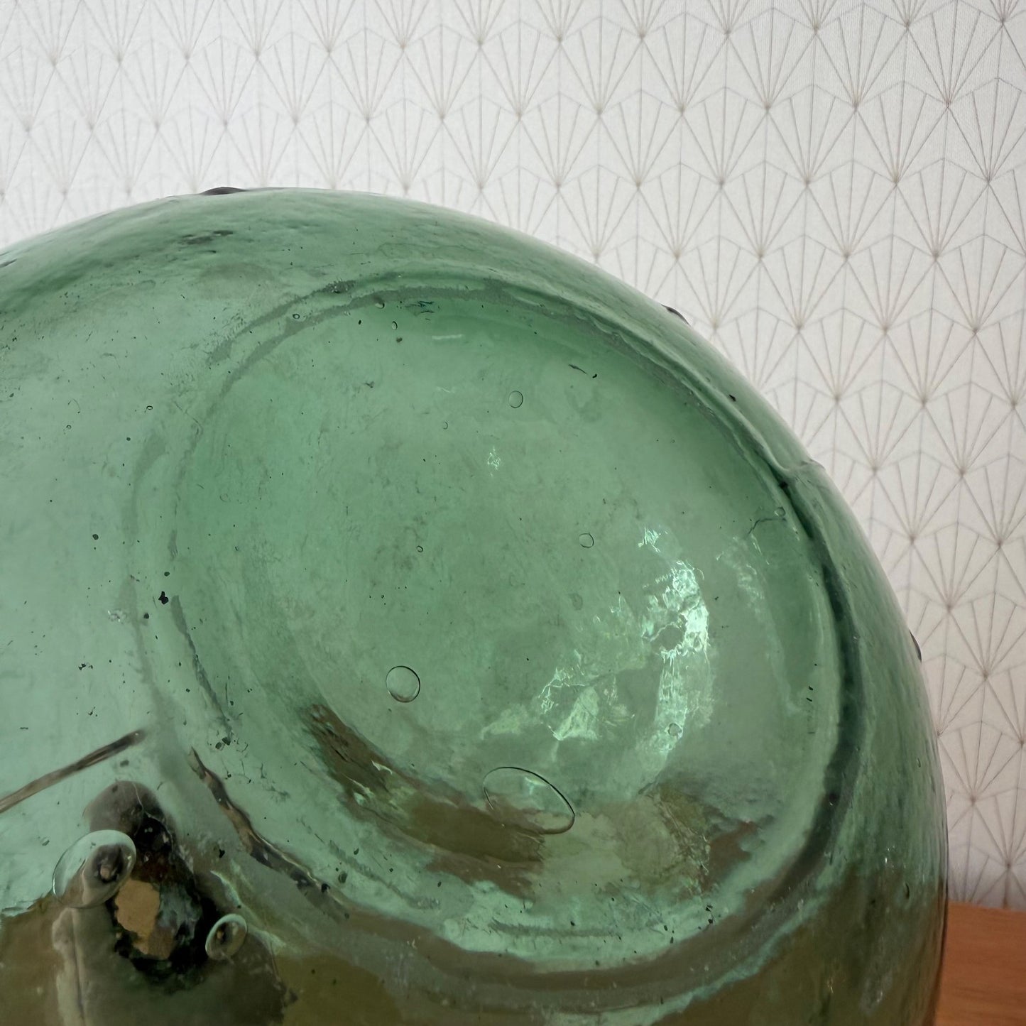 Bottom detail of antique French bonbonne glass demijohn showing pontil mark and age patina
