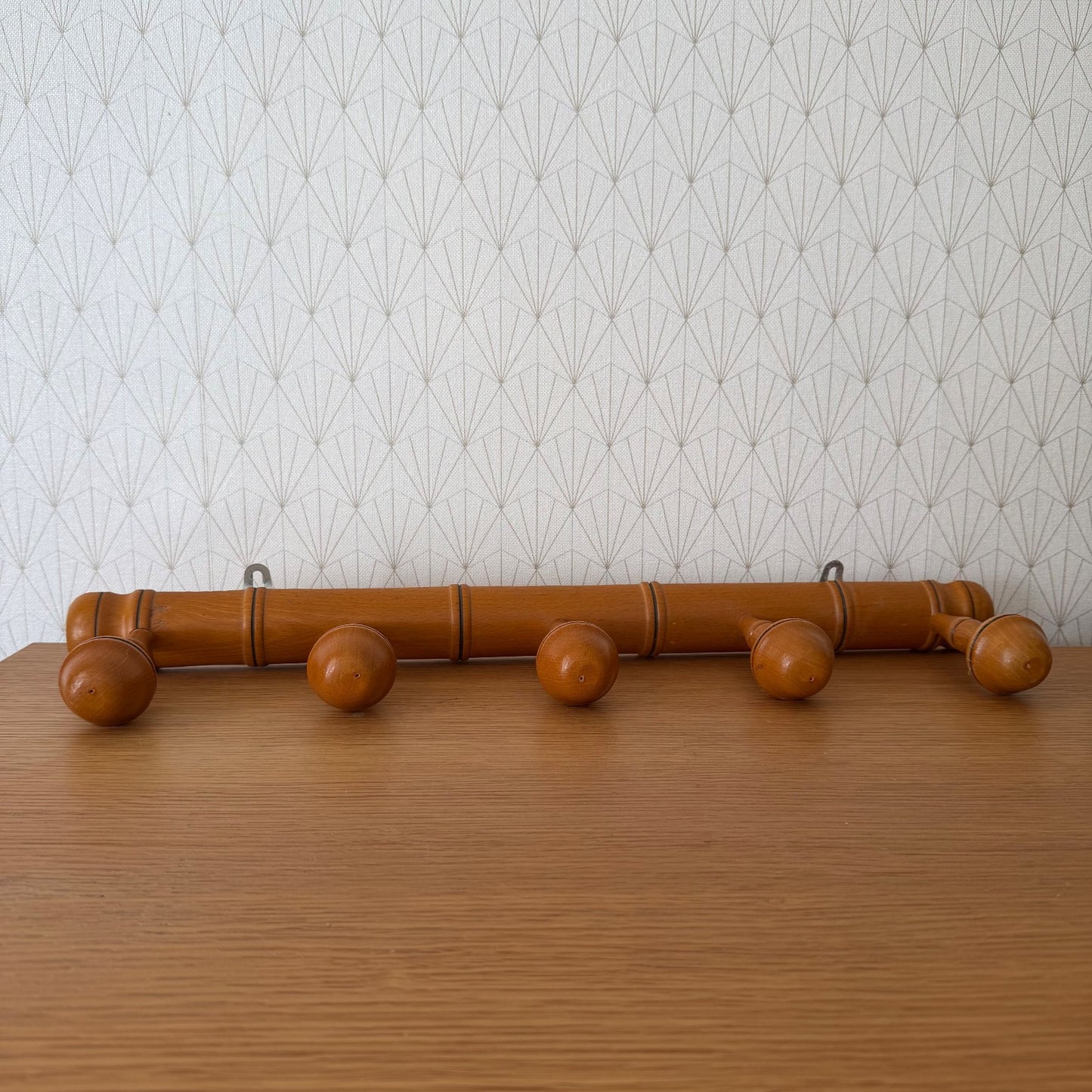 French vintage bamboo coat rack with five wooden pegs and black rings, wall-mounted