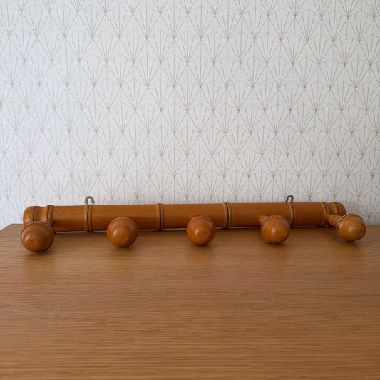 French vintage bamboo coat rack with five wooden pegs and black rings, wall-mounted
