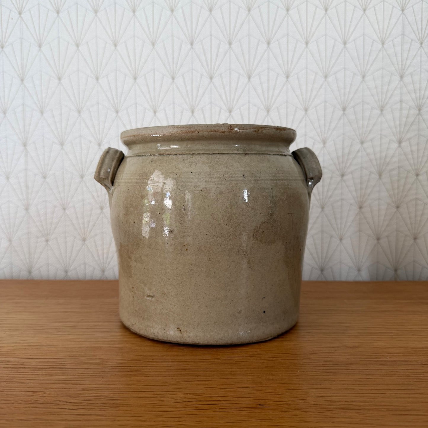 French antique stoneware confit pot with two loop handles, beige-grey glaze, front view