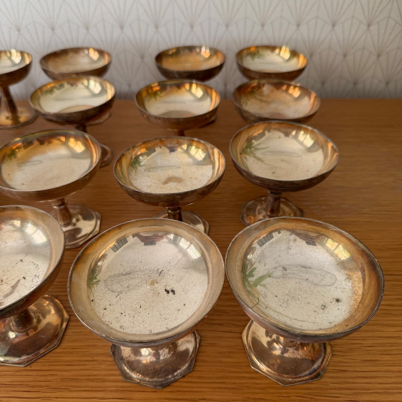 Overhead angle of vintage silverplate champagne coupes compotes showing shallow bowls and metal oxidation patterns
