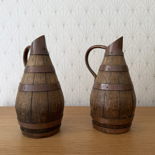Pair of antique French wooden wine pitchers with metal bands and handles