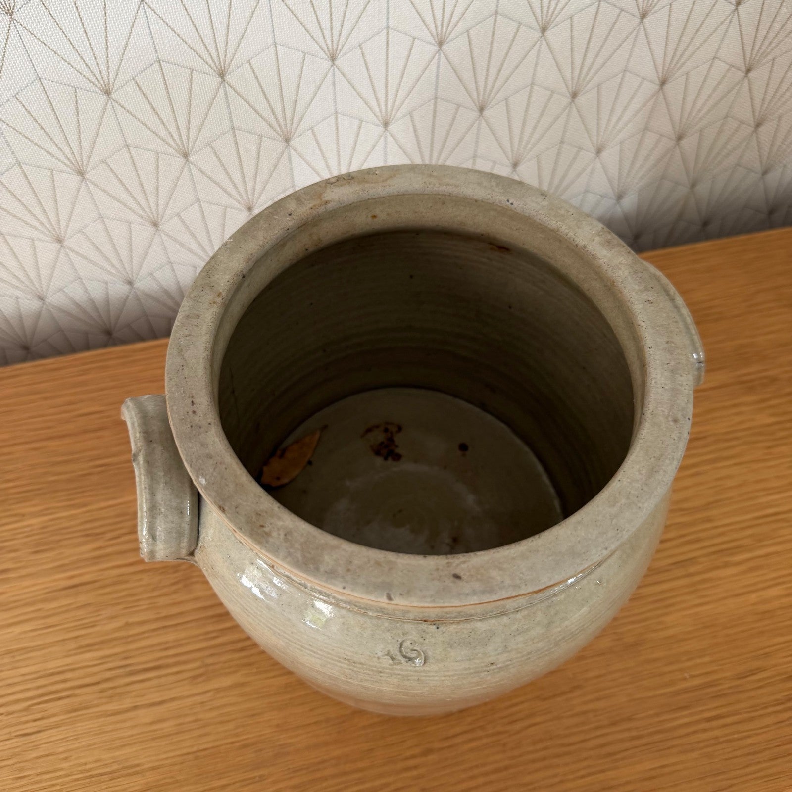 Front facing French antique stoneware confit pot with characteristic loop handles