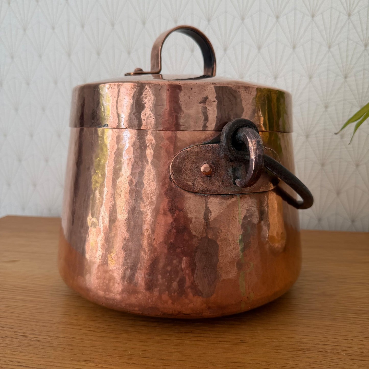 Angled view of authentic French copper cauldron with decorative swing handle