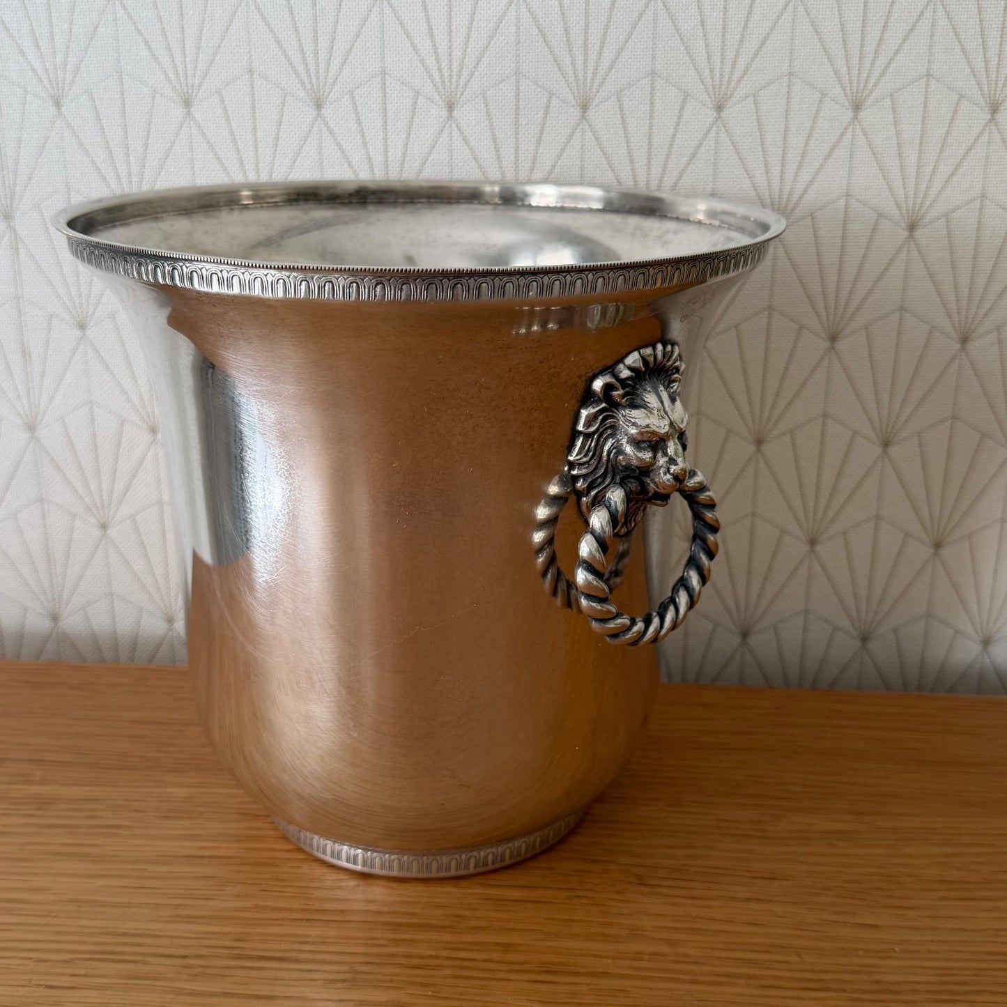 Wide angle view showing French silverplate champagne bucket lion handle and polished finish