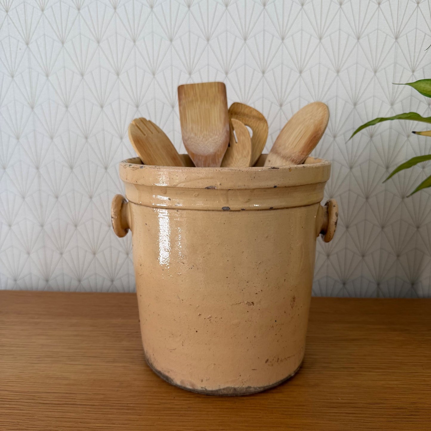 Antique French stoneware crock with wooden utensils, ochre glazed storage jar