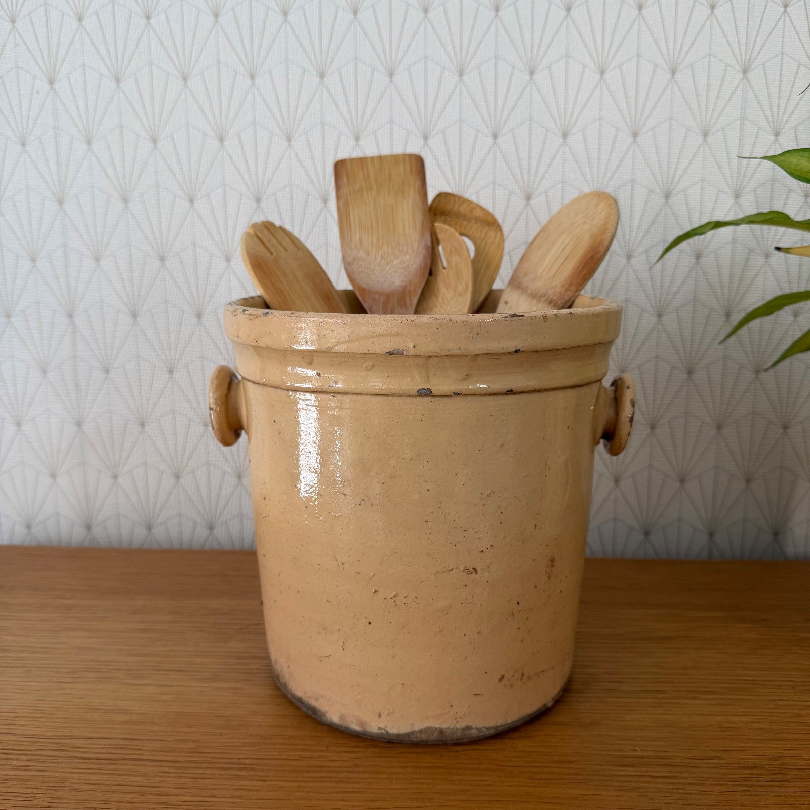 Antique French stoneware crock with wooden utensils, ochre glazed storage jar