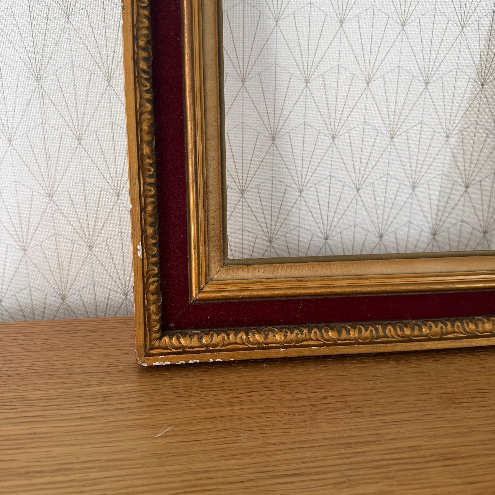 Side profile of French vintage gold picture frame showing layered red velvet and gilt finish construction