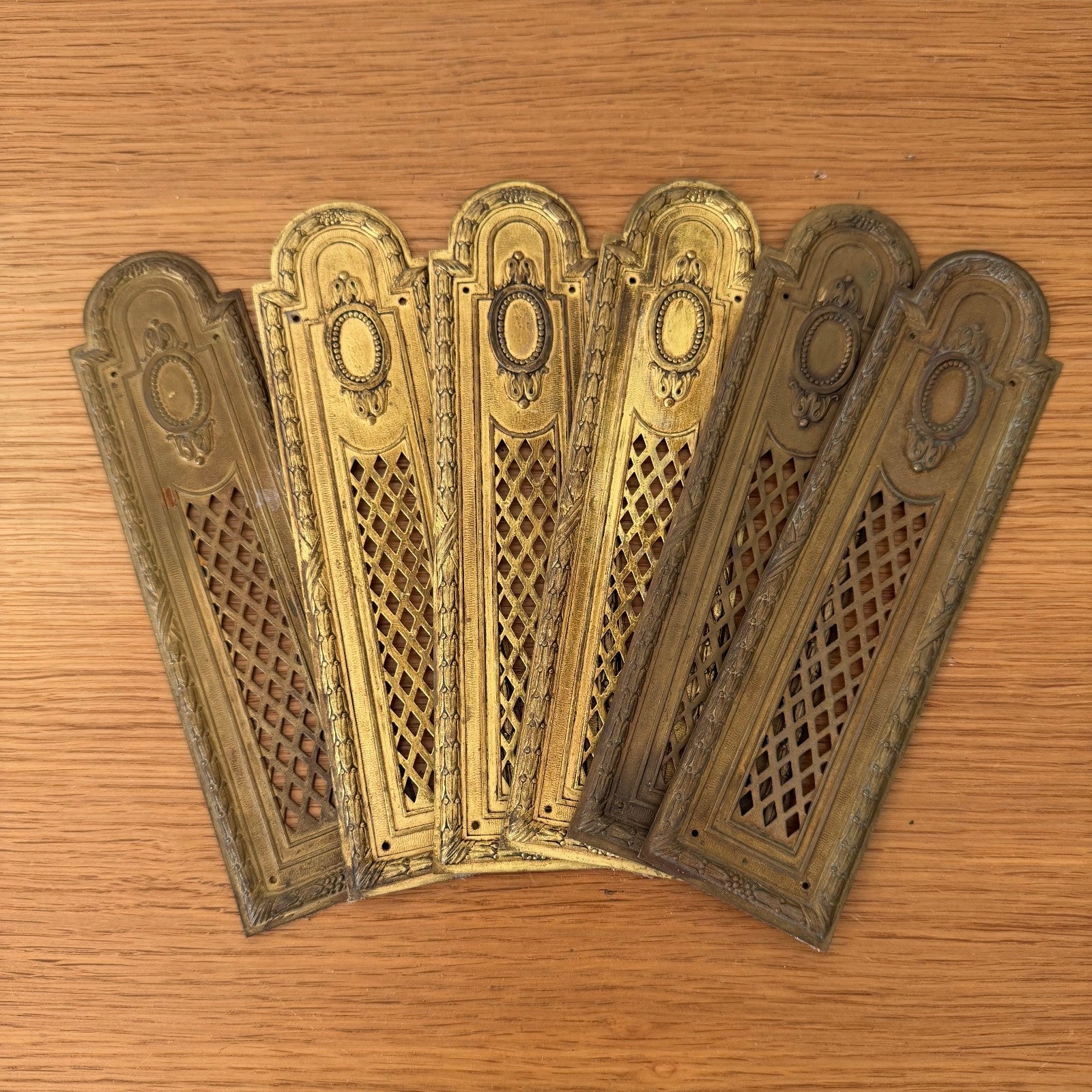 Set of 6 French vintage brass door plates Louis XVI style with ornate oval medallions and diamond lattice pattern