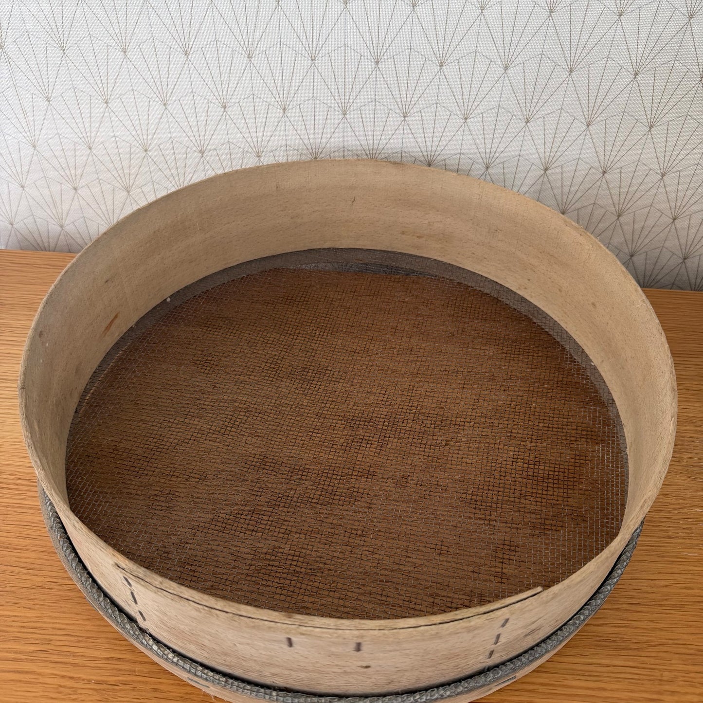 Interior detail of French wooden flour sieve with fine mesh sifting base