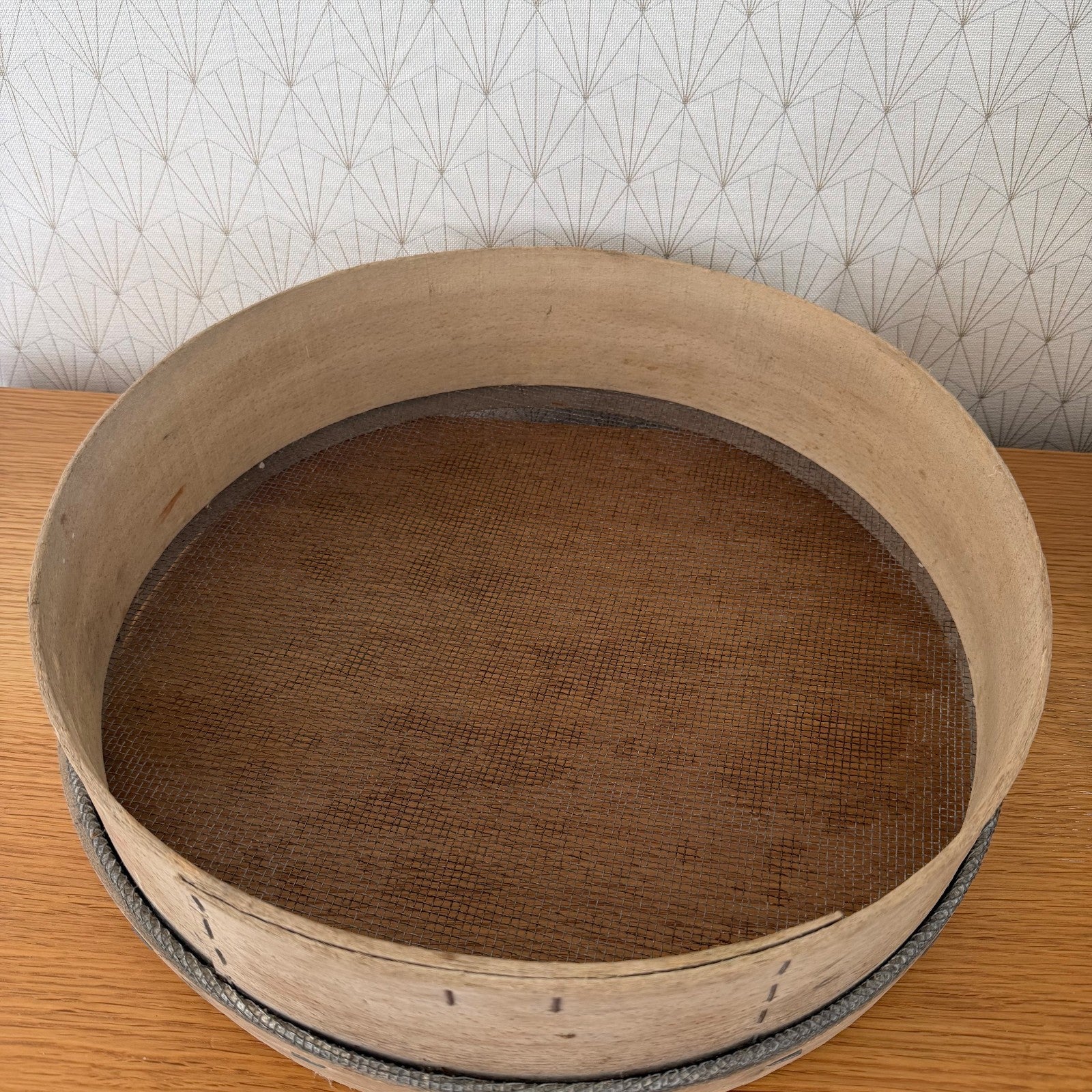 Interior detail of French wooden flour sieve with fine mesh sifting base