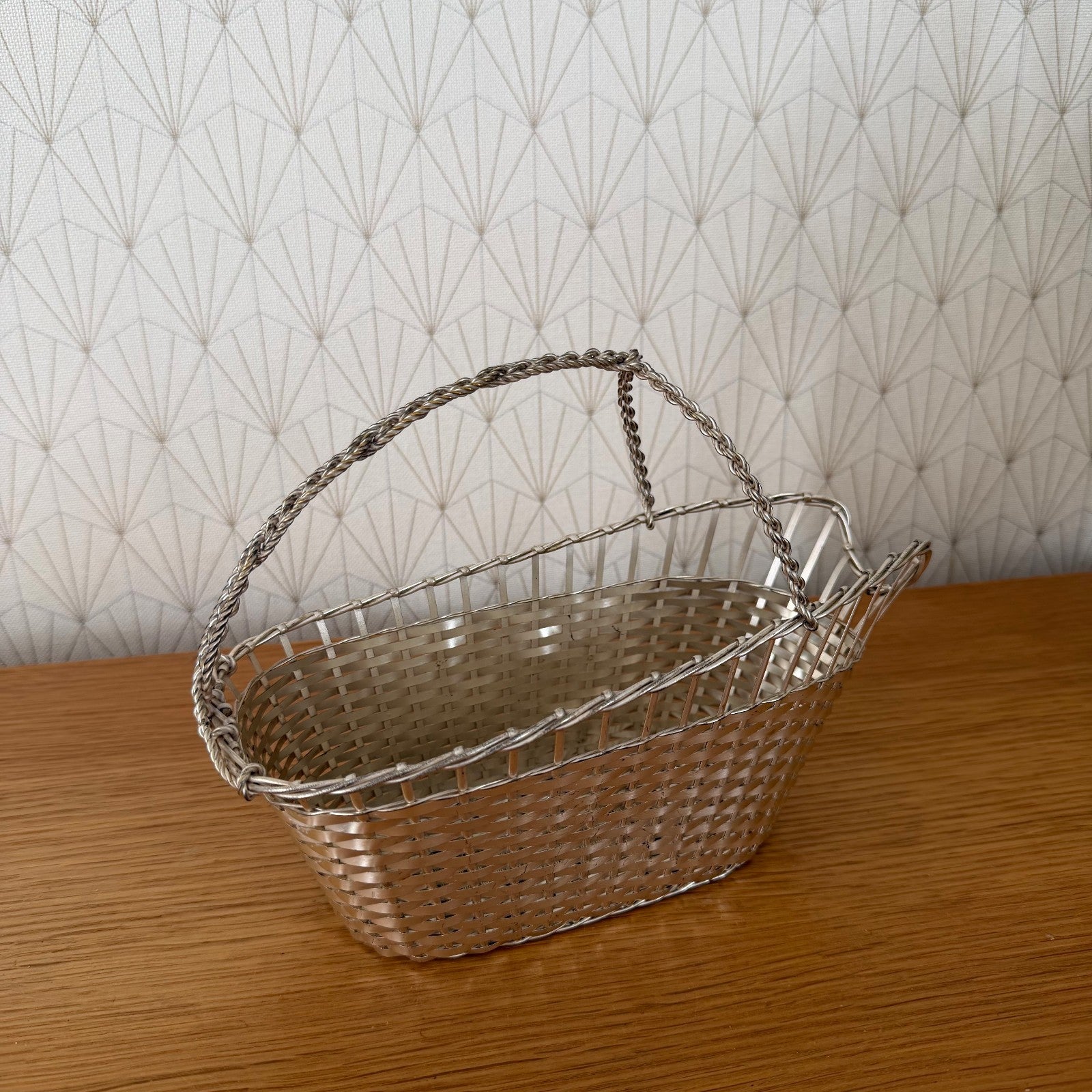 Vintage silver plated wine basket showing woven metal construction and side profile