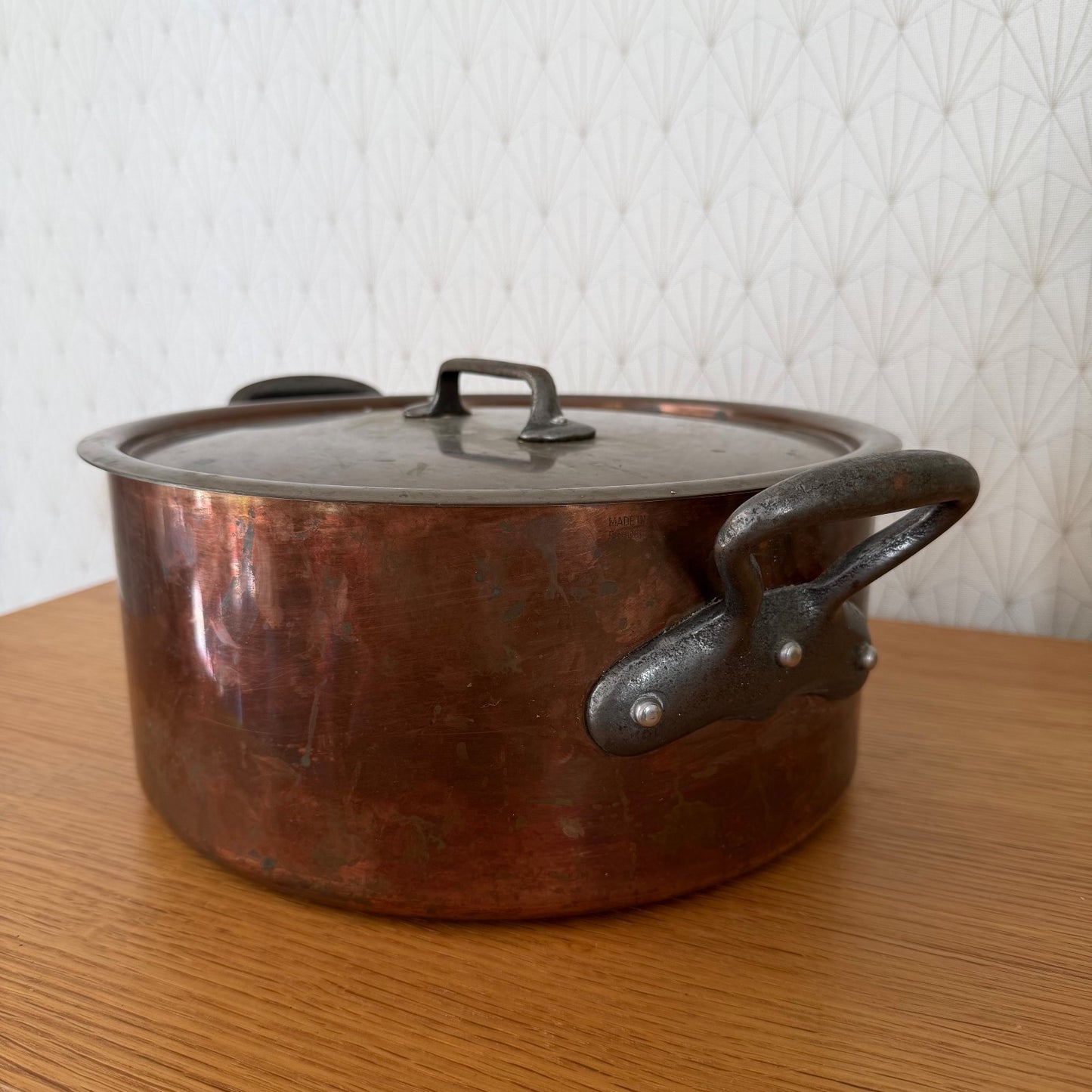 Side profile of vintage French copper cocotte showing classic braising pot form